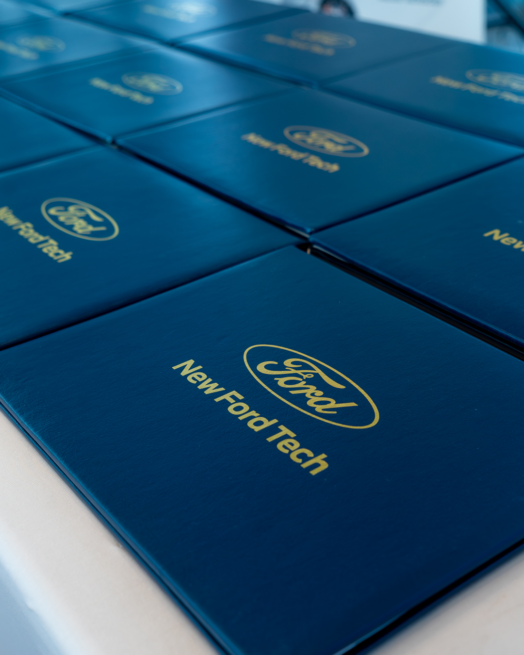 A bunch of New Ford Tech graduation certificates lined up on a table