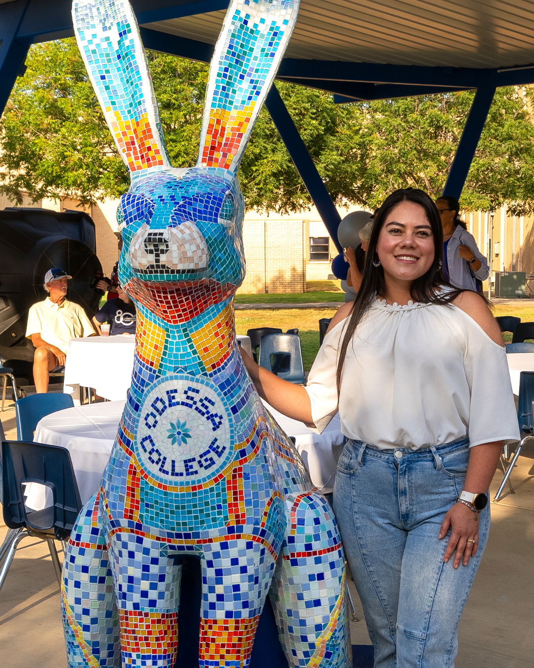 Yennifer Cano Rojas standing next to the new mosaic jackrabbit statue