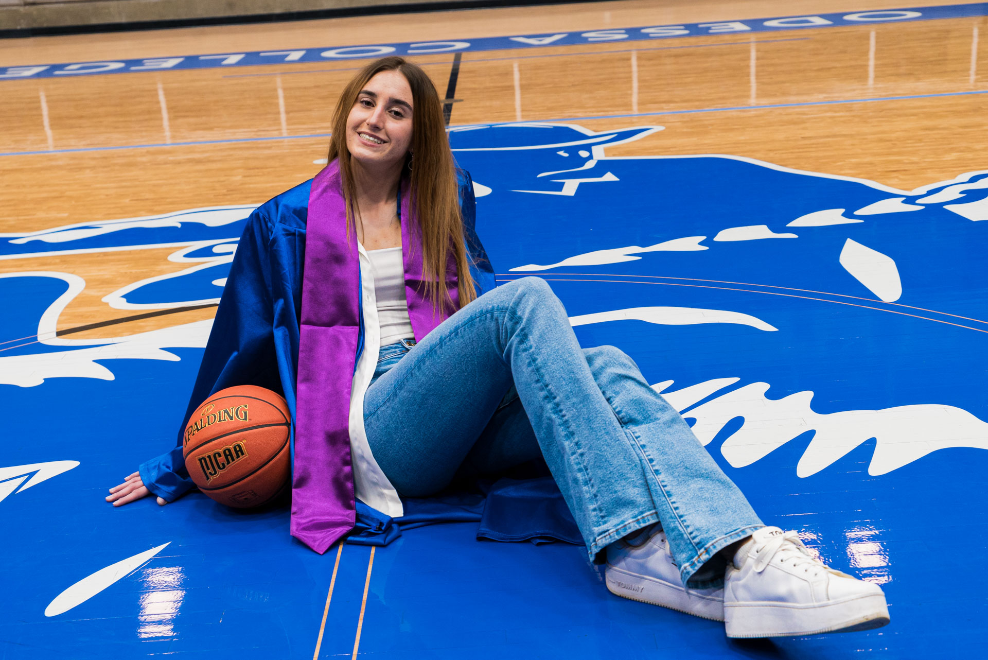 Ivana sitting with a basketball ball