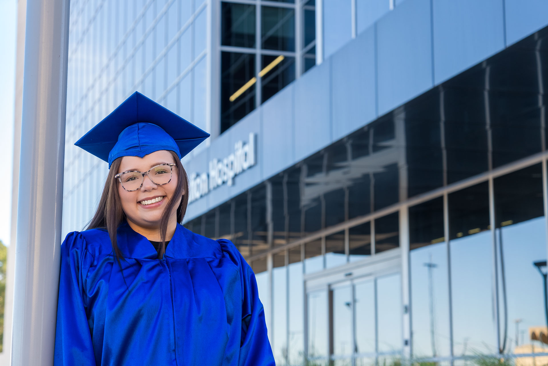Aide Medina posing next to the Sim Hospital
