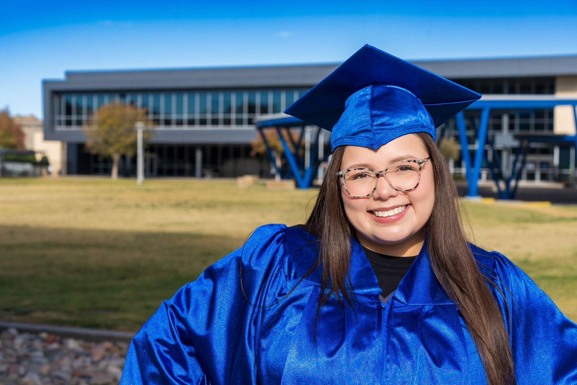 Aide Medina smiling in front of amphitheater