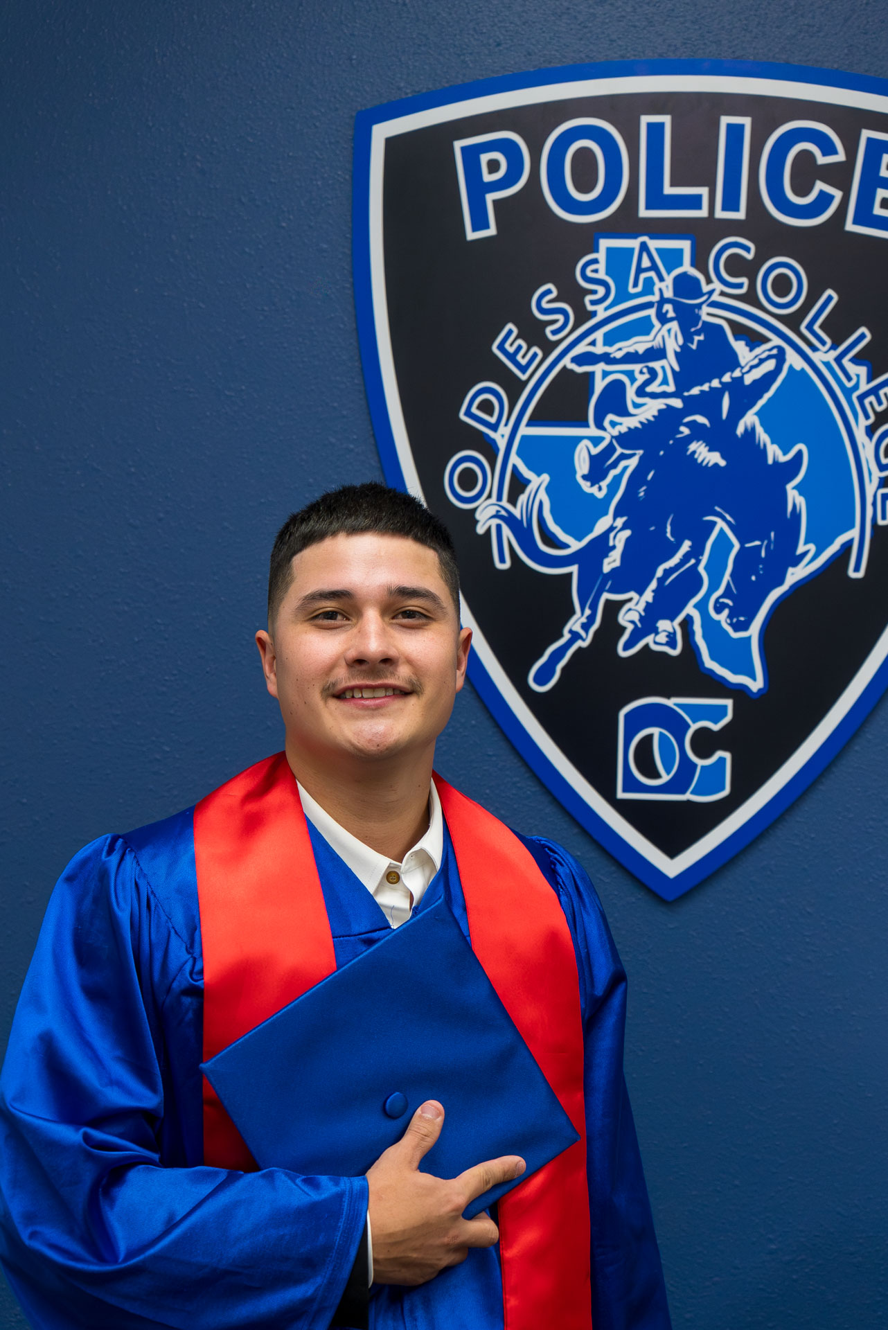 Aldo posing in front of OC Police logo