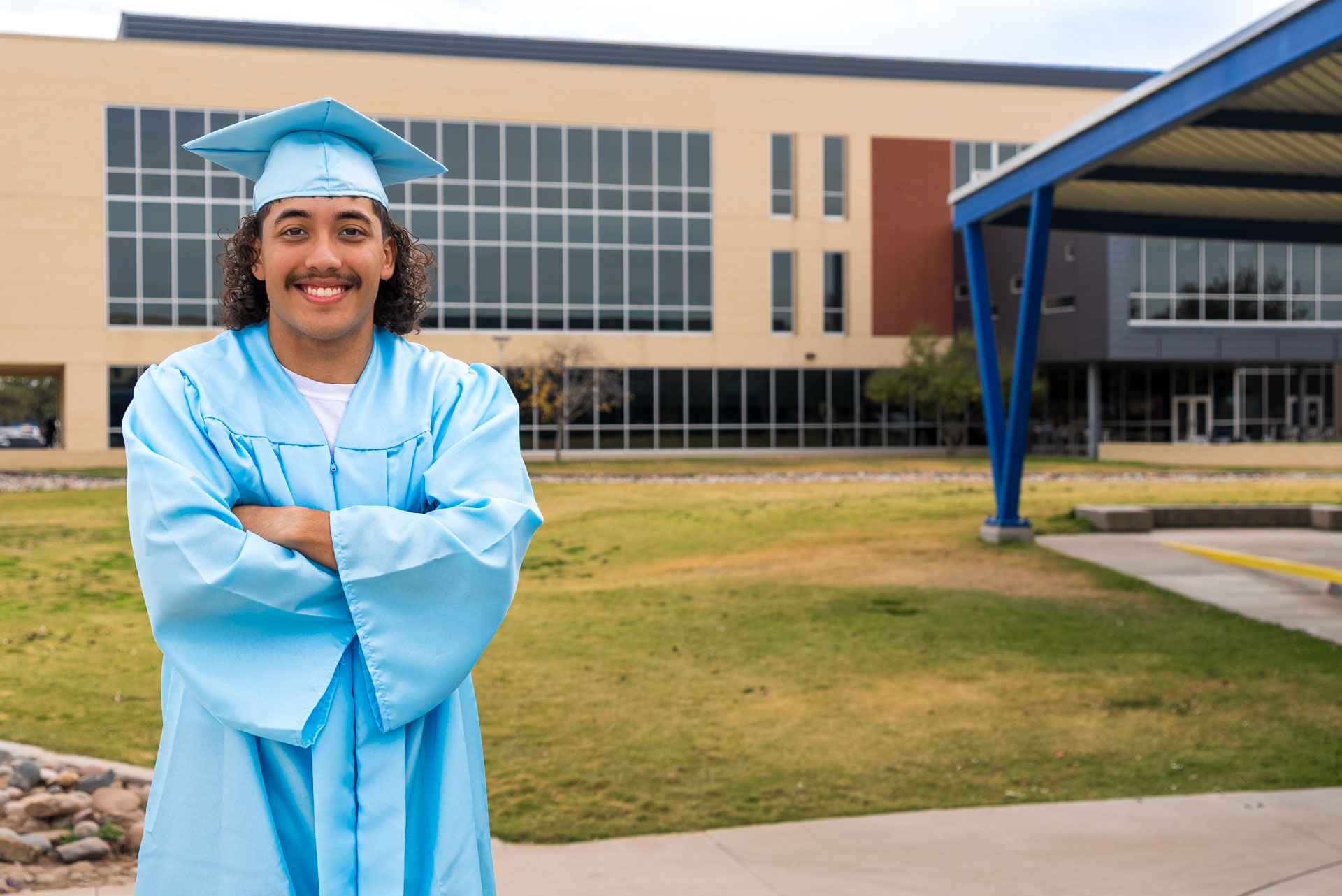 Julien Martinez smiling in front of building