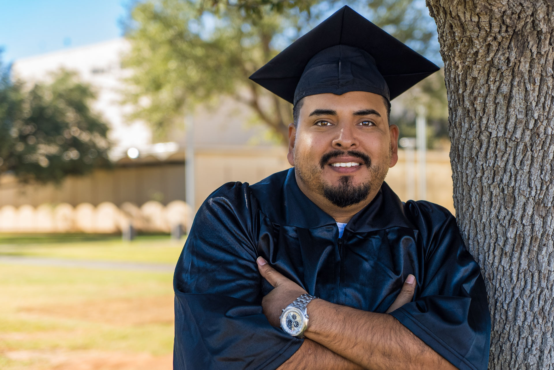 Luis Sigala next to a tree with arms crossed