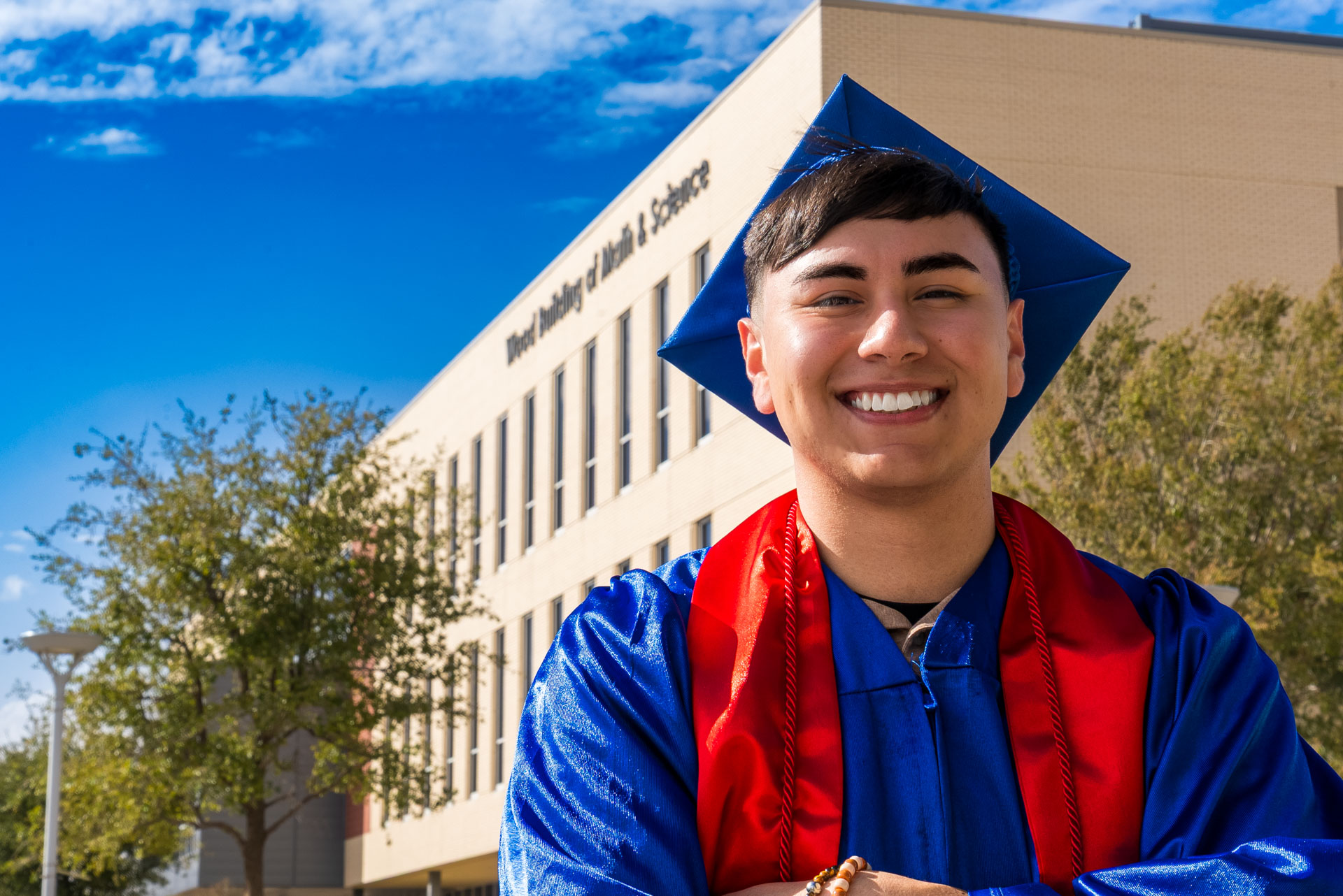 Raul Barrera smiling in front of building