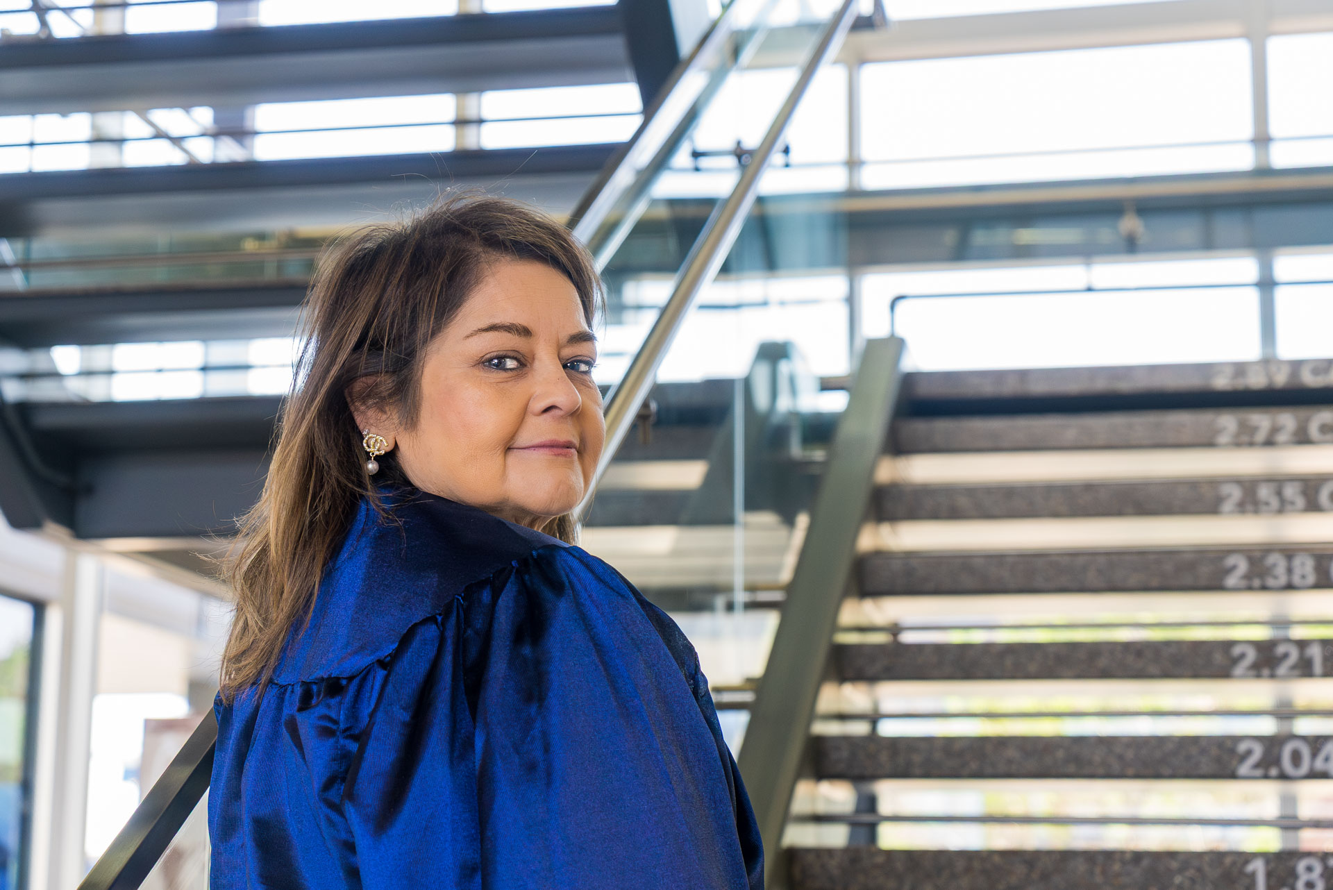 Jeanette Martinez looking back at the camera on stairs
