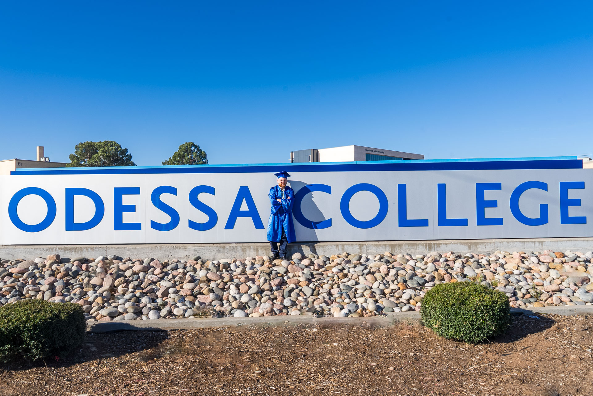 Carter Hunt leaning against OC sign