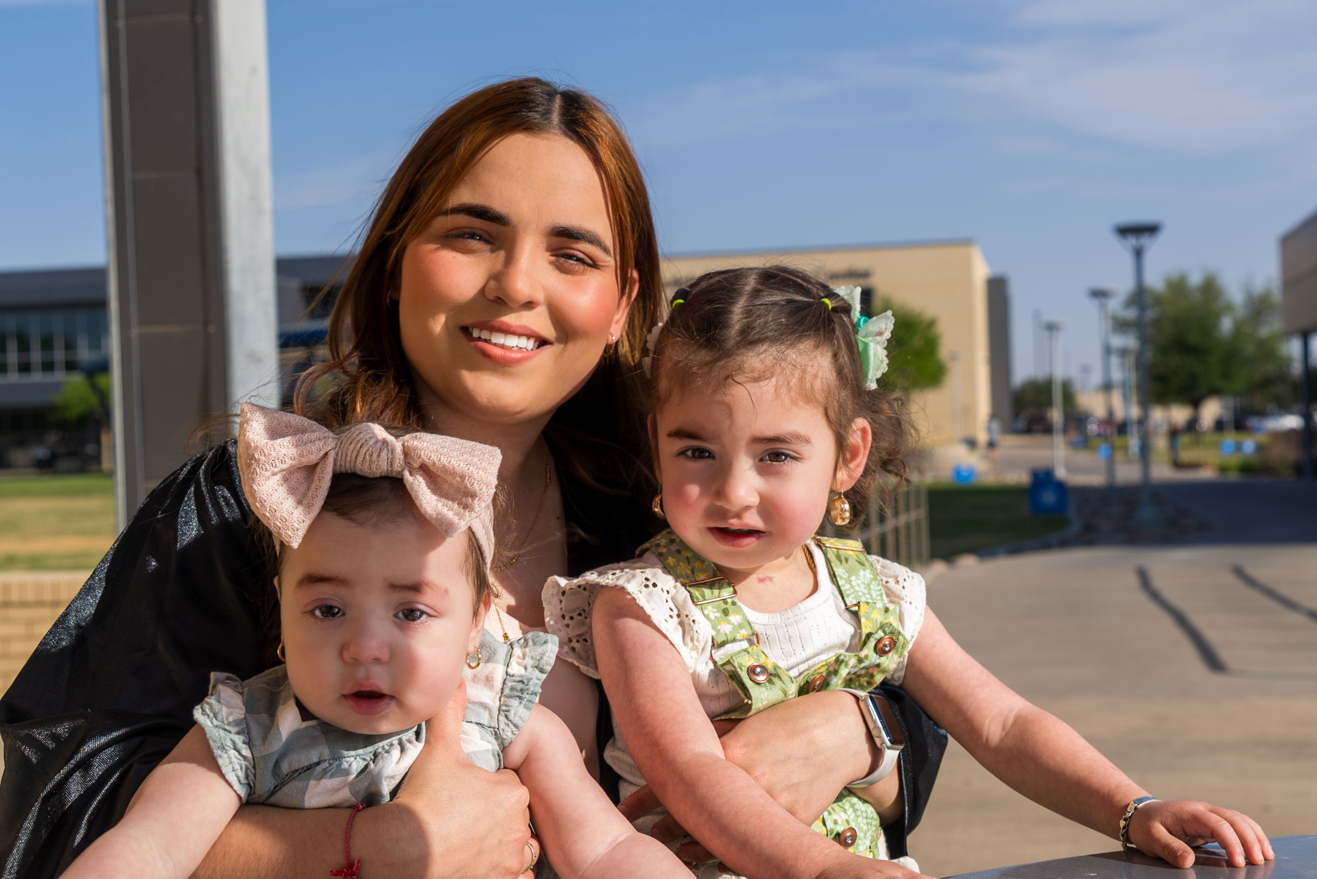 Gissell Fabela siting and posing with two daughters