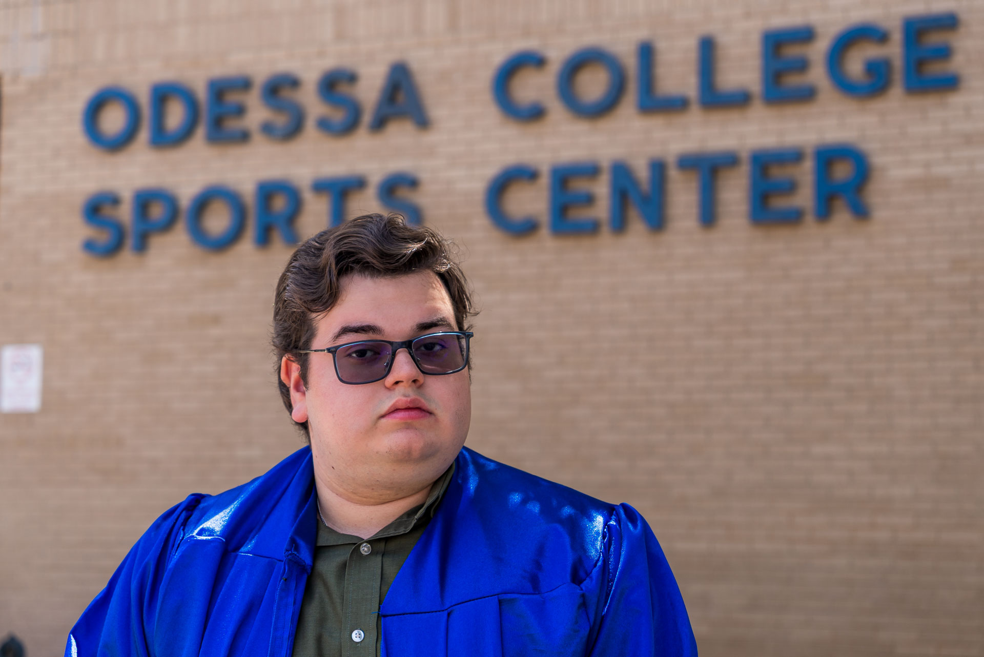 Joel Alvidrez with sunglasses in front of sports center