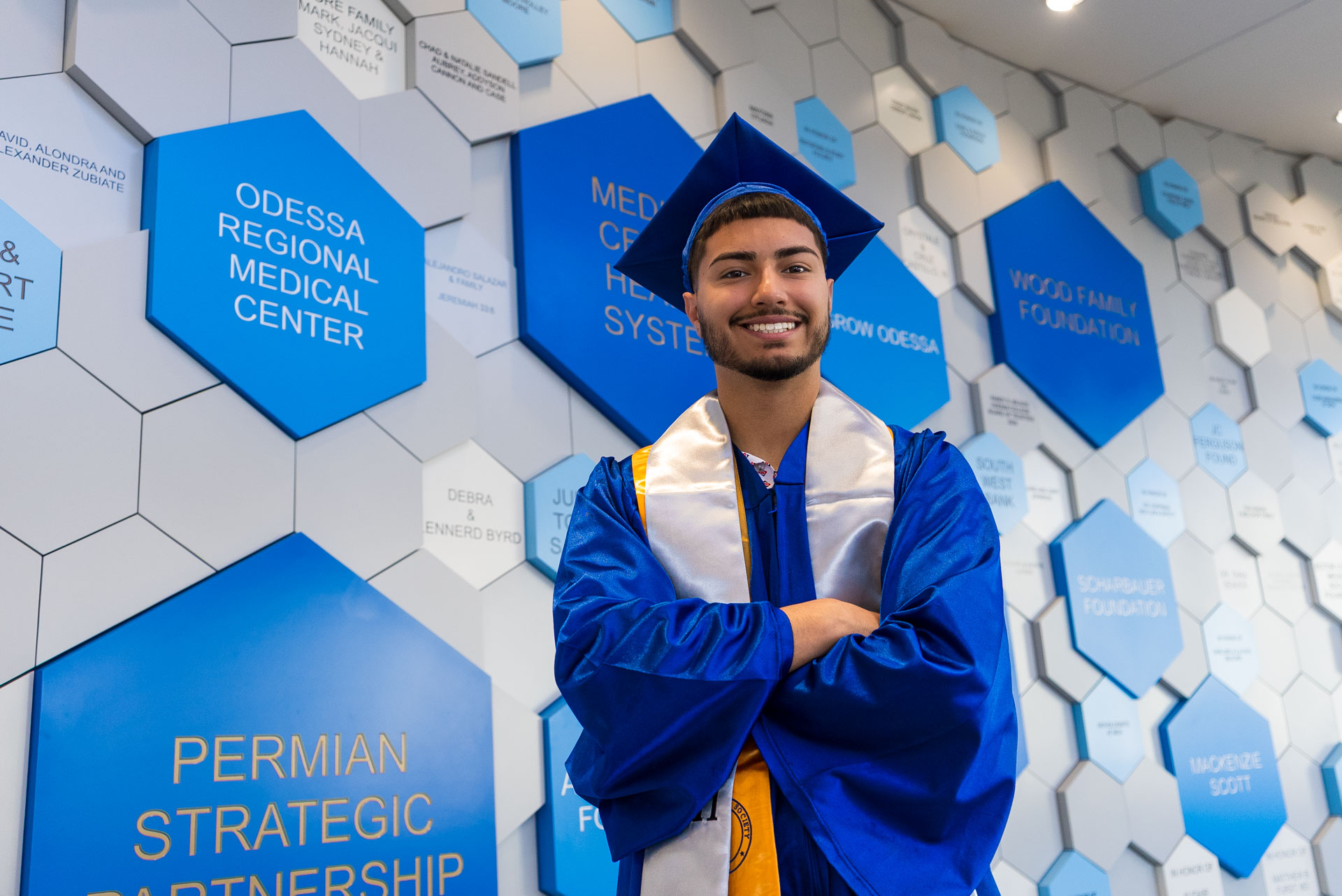Luis Munoz standing in front of wall with blue and gray hexagons