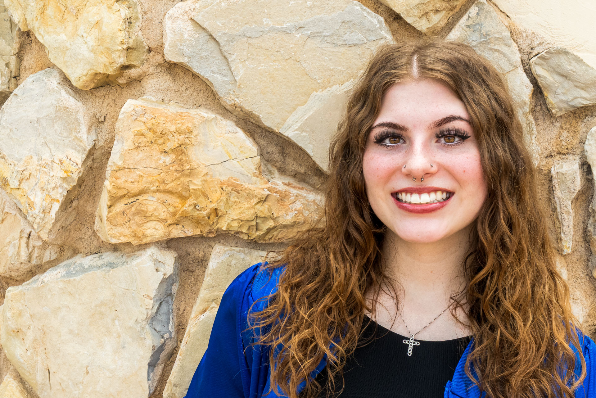 Maggie in front of stone wall