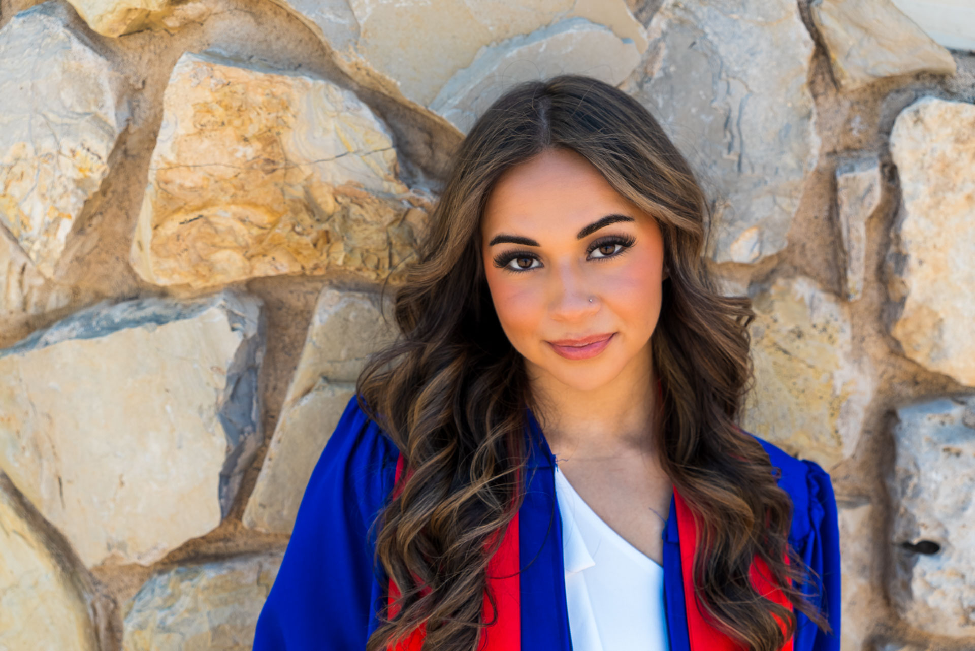 Nevaeh Martinez leaning on stone wall
