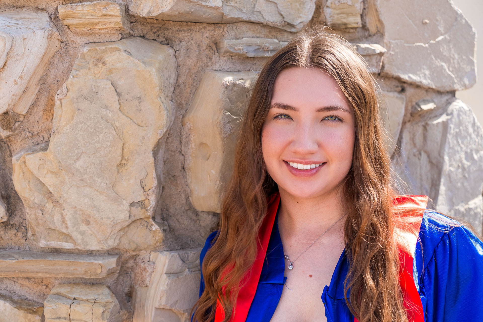 Aubree Lara posing against a stone wall